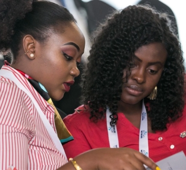 Two female network partners look at a document.